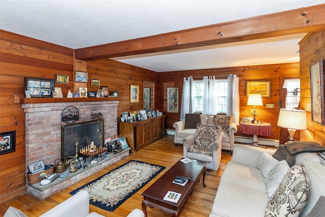 12 Greentree Ct, Northport, NY 11768 - living room featuring light wood-style flooring, beam ceiling, wood walls, a brick fireplace, and a baseboard heating unit