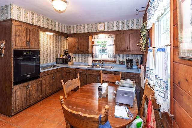 12 Greentree Ct, Northport, NY 11768 - kitchen featuring black appliances, wallpapered walls, light tile patterned floors, light countertops, and brown cabinets