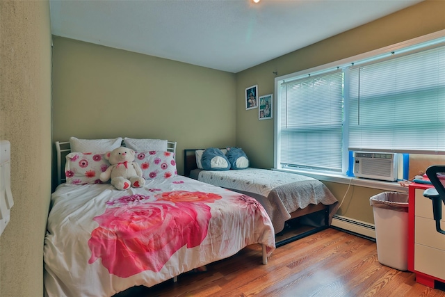 22 Indian Ave, Flanders, NY 11901 - bedroom featuring a baseboard radiator, wood finished floors, and cooling unit