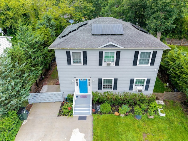 22 Indian Ave, Flanders, NY 11901 - view of front of house featuring roof with shingles and roof mounted solar panels