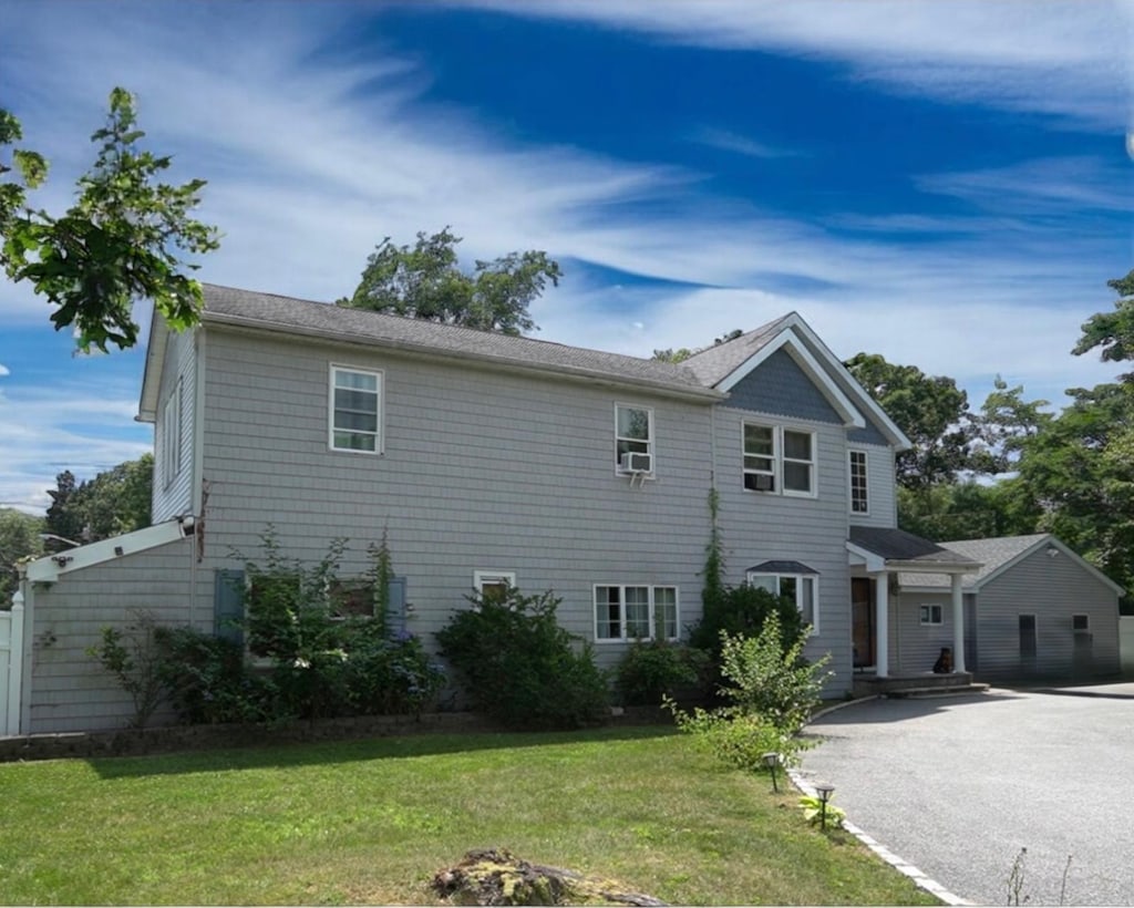 1264 Connetquot Ave, Central Islip, NY 11722 - view of front of house featuring a front yard and asphalt driveway