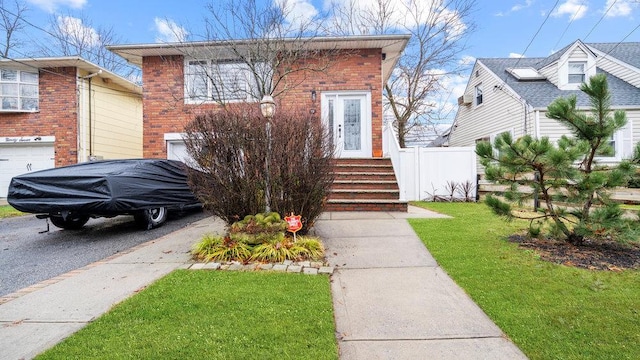 95 Foster Ave, Valley Stream, NY 11580 - view of front of home with an attached garage, driveway, and brick siding