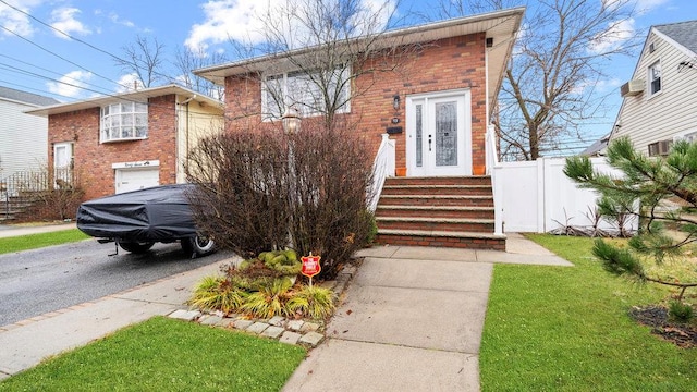 95 Foster Ave, Valley Stream, NY 11580 - view of front facade featuring brick siding and asphalt driveway