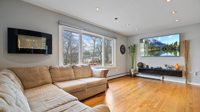95 Foster Ave, Valley Stream, NY 11580 - living room featuring a baseboard radiator, recessed lighting, and wood finished floors