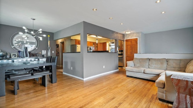 95 Foster Ave, Valley Stream, NY 11580 - living area featuring a chandelier, light wood-type flooring, and recessed lighting