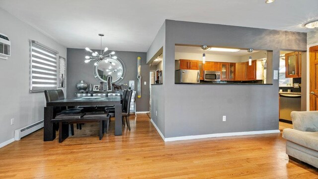 95 Foster Ave, Valley Stream, NY 11580 - dining space with a baseboard radiator, a chandelier, and light wood-style flooring