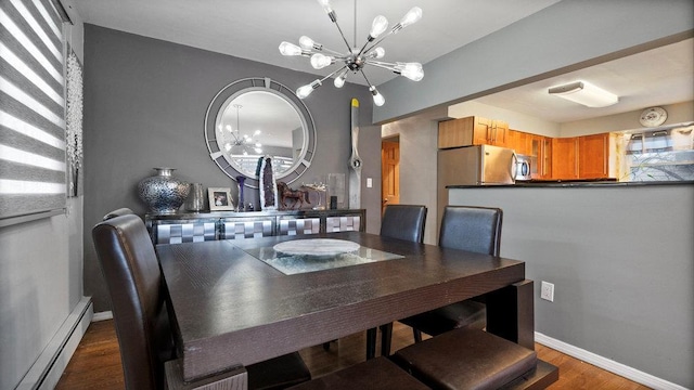 95 Foster Ave, Valley Stream, NY 11580 - dining area with a baseboard heating unit, a chandelier, and dark wood-style flooring