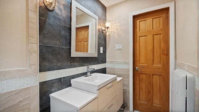 95 Foster Ave, Valley Stream, NY 11580 - bathroom featuring tile walls, vanity, and wainscoting
