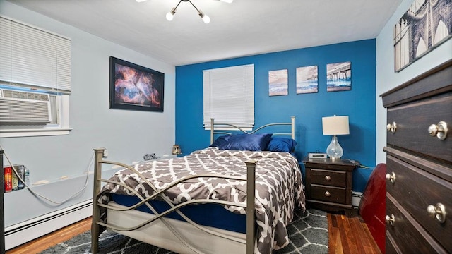 95 Foster Ave, Valley Stream, NY 11580 - bedroom with wood finished floors, a baseboard heating unit, and cooling unit