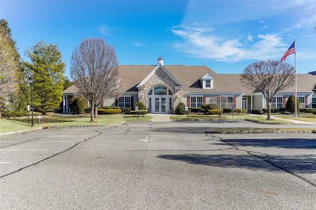 109 Louden Loop, Mount Sinai, NY 11766 - view of front facade featuring french doors, stone siding, and a front yard