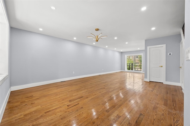 24-08 97th St, East Elmhurst, NY 11369 - empty room featuring wood-type flooring and recessed lighting