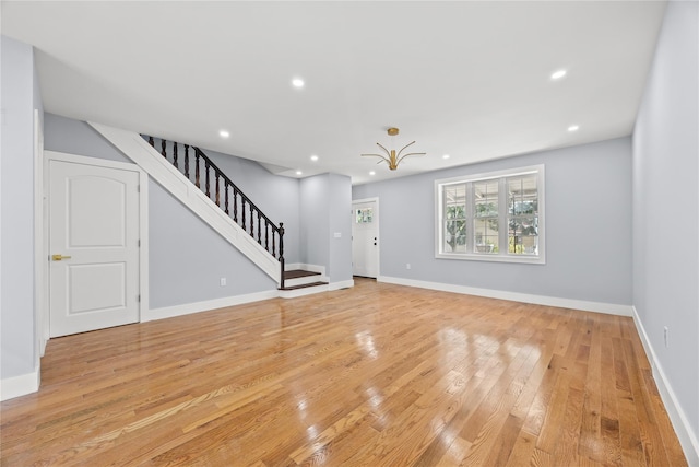 24-08 97th St, East Elmhurst, NY 11369 - unfurnished living room with stairway, light wood finished floors, and recessed lighting