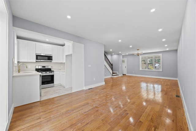 24-08 97th St, East Elmhurst, NY 11369 - unfurnished living room with stairway, recessed lighting, and light wood-style floors