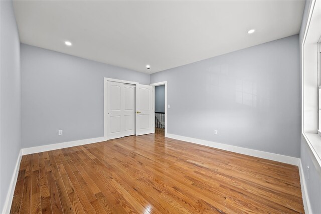 24-08 97th St, East Elmhurst, NY 11369 - unfurnished bedroom featuring wood finished floors, a closet, and recessed lighting