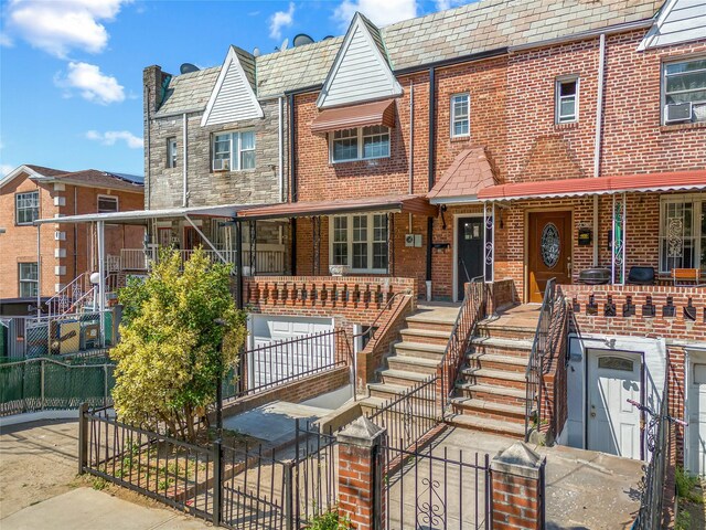 24-08 97th St, East Elmhurst, NY 11369 - townhome / multi-family property with brick siding, stairway, and a high end roof