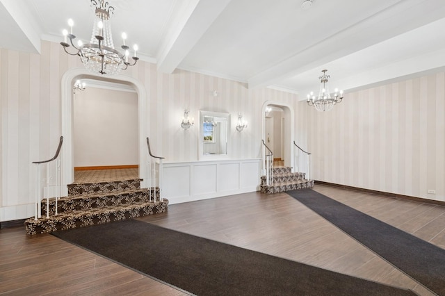 102 S Village Ave Unit 3A, Rockville Centre, NY 11570 - exercise area with wallpapered walls, arched walkways, a chandelier, wood finished floors, and ornamental molding