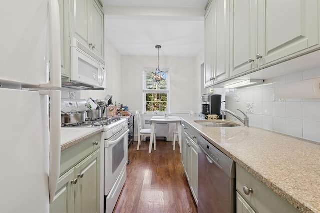 102 S Village Ave Unit 3A, Rockville Centre, NY 11570 - kitchen with white appliances, dark wood finished floors, decorative backsplash, decorative light fixtures, and light stone counters