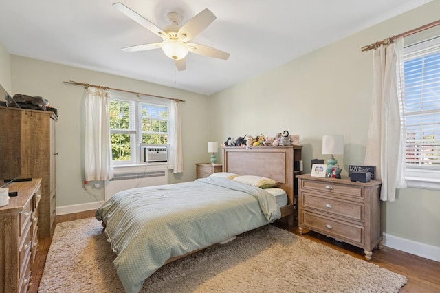 102 S Village Ave Unit 3A, Rockville Centre, NY 11570 - bedroom featuring radiator heating unit, wood finished floors, cooling unit, and ceiling fan