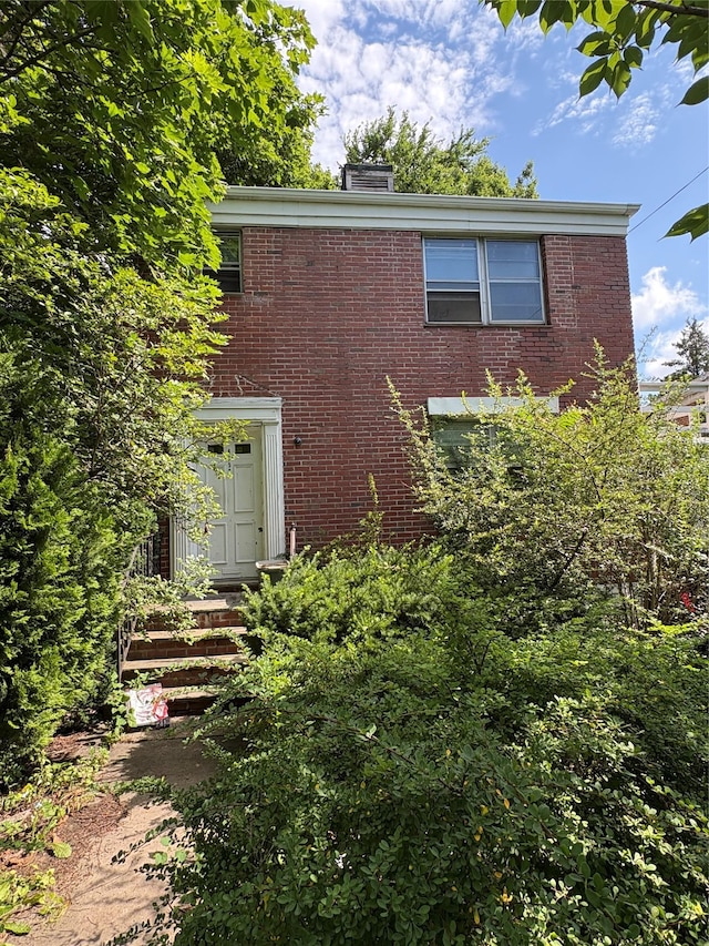 425 W 256th St, Bronx, NY 10471 - view of front facade featuring brick siding and a chimney