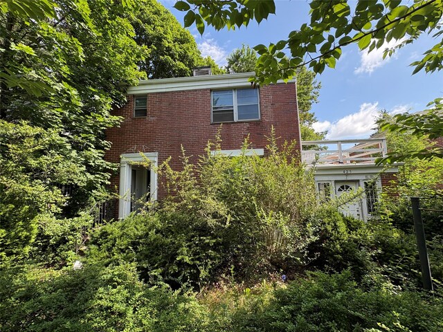 425 W 256th St, Bronx, NY 10471 - view of side of property with brick siding and a chimney