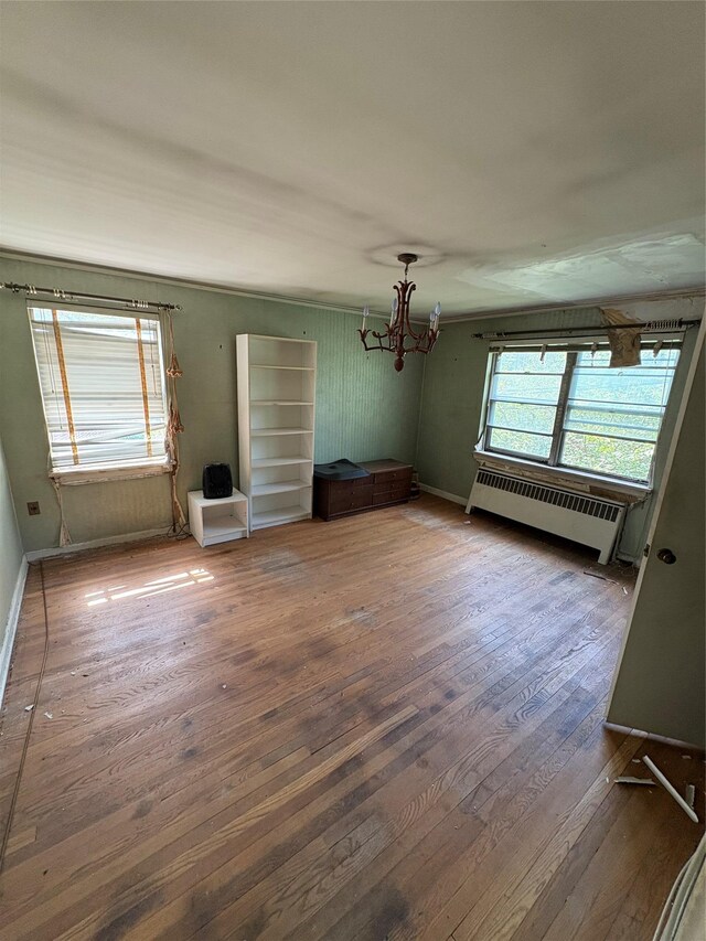 425 W 256th St, Bronx, NY 10471 - unfurnished room with radiator heating unit, a chandelier, and hardwood / wood-style floors