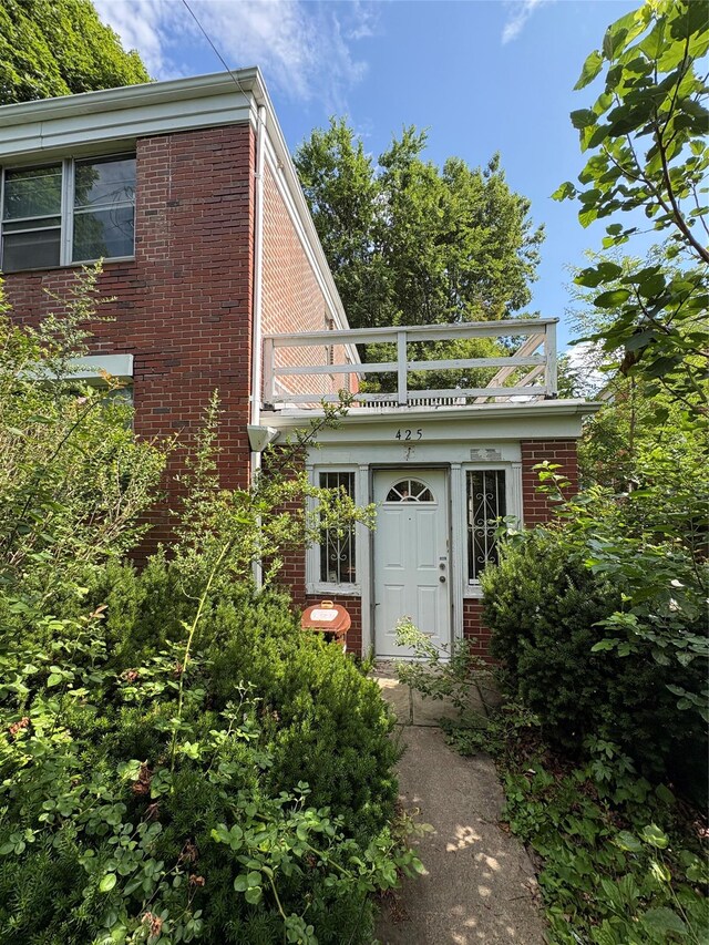 425 W 256th St, Bronx, NY 10471 - doorway to property with brick siding and a balcony