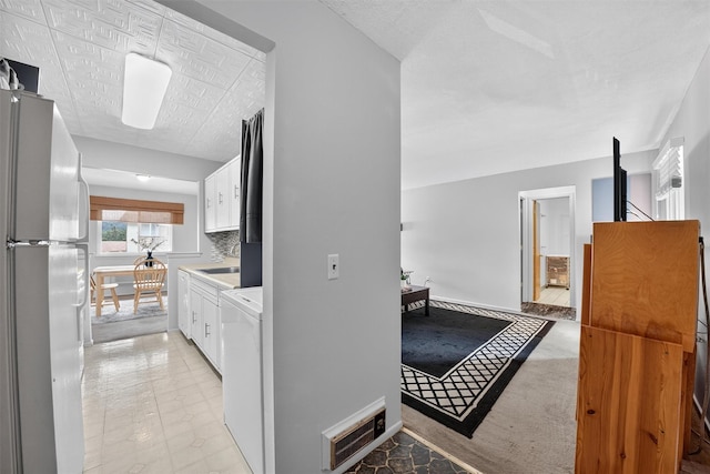 17 Village Park Dr Unit 3A, Fishkill, NY 12524 - kitchen with freestanding refrigerator, white cabinetry, and light countertops