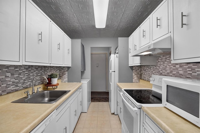 17 Village Park Dr Unit 3A, Fishkill, NY 12524 - kitchen featuring white appliances, under cabinet range hood, washer / dryer, white cabinetry, and an ornate ceiling