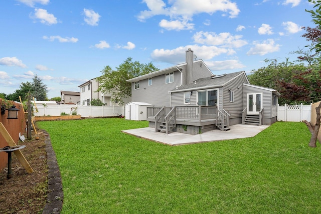 2572 Riverside Ave, Seaford, NY 11783 - rear view of property with french doors, a fenced backyard, a wooden deck, a storage shed, and a chimney