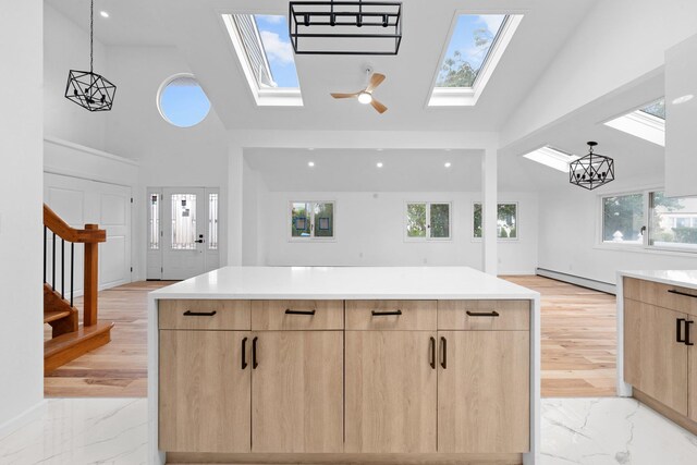 2572 Riverside Ave, Seaford, NY 11783 - kitchen with light brown cabinets, modern cabinets, high vaulted ceiling, a skylight, and baseboard heating