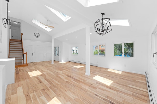 2572 Riverside Ave, Seaford, NY 11783 - unfurnished living room featuring a skylight, a baseboard heating unit, high vaulted ceiling, and light wood-style floors
