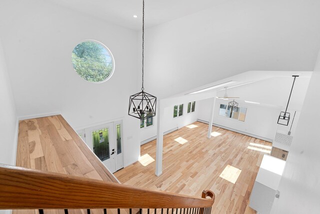 2572 Riverside Ave, Seaford, NY 11783 - bonus room with wood finished floors, a high ceiling, a chandelier, and french doors