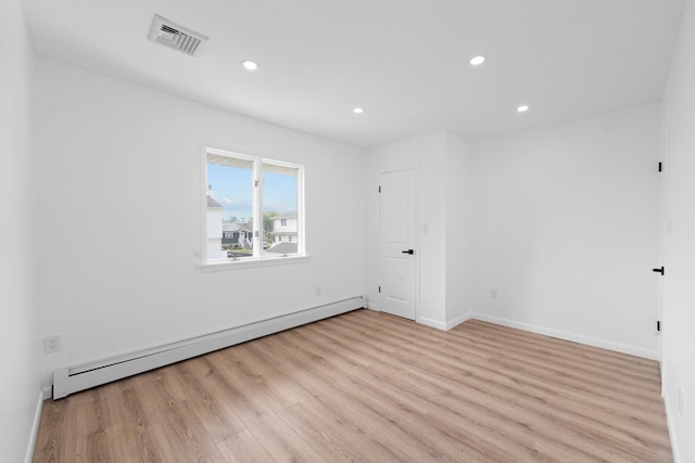 2572 Riverside Ave, Seaford, NY 11783 - empty room featuring baseboard heating, light wood-style floors, and recessed lighting
