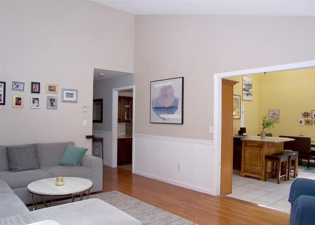 2189 Cedar Ave, Ronkonkoma, NY 11779 - living area featuring light wood-style floors and a towering ceiling