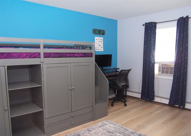 2189 Cedar Ave, Ronkonkoma, NY 11779 - bedroom with cooling unit, light wood finished floors, and a desk