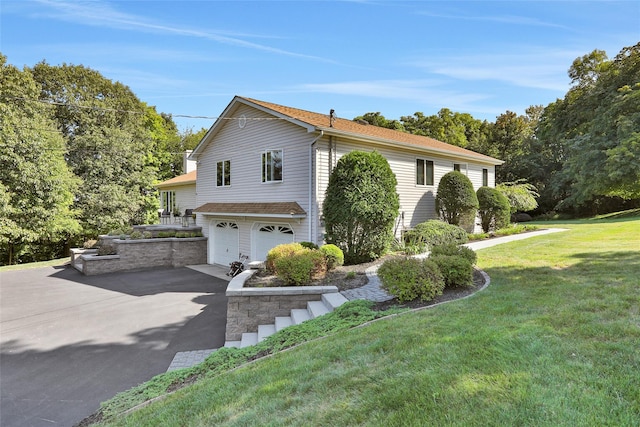 35 Lattintown Rd, Newburgh, NY 12550 - view of front of house featuring a garage, asphalt driveway, and a front lawn