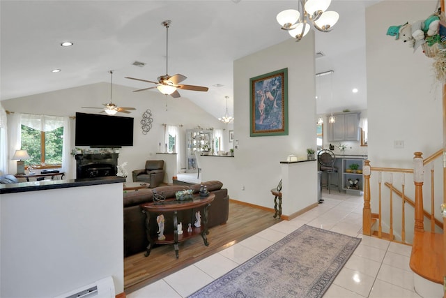 35 Lattintown Rd, Newburgh, NY 12550 - living area featuring a fireplace, baseboard heating, a chandelier, vaulted ceiling, and light tile patterned floors