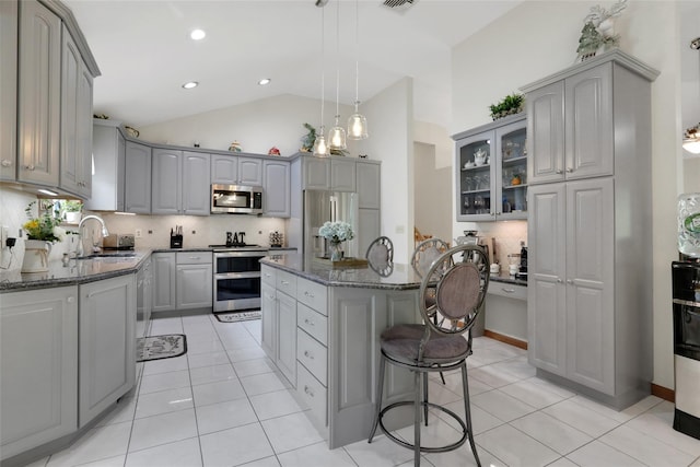 35 Lattintown Rd, Newburgh, NY 12550 - kitchen featuring stainless steel appliances, gray cabinets, light tile patterned floors, decorative backsplash, and a center island