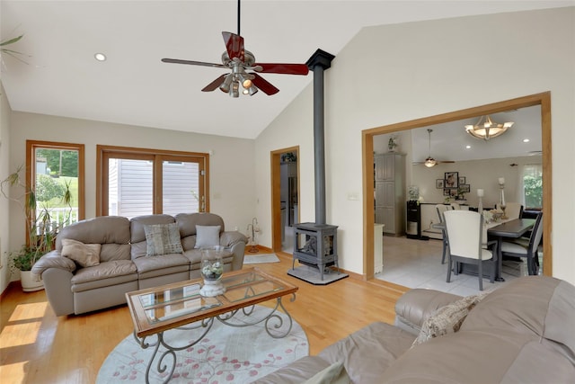 35 Lattintown Rd, Newburgh, NY 12550 - living room with a wood stove, ceiling fan, healthy amount of natural light, light wood-style flooring, and high vaulted ceiling