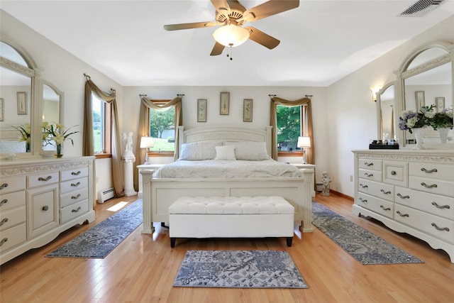 35 Lattintown Rd, Newburgh, NY 12550 - bedroom featuring multiple windows, a baseboard radiator, and light wood finished floors