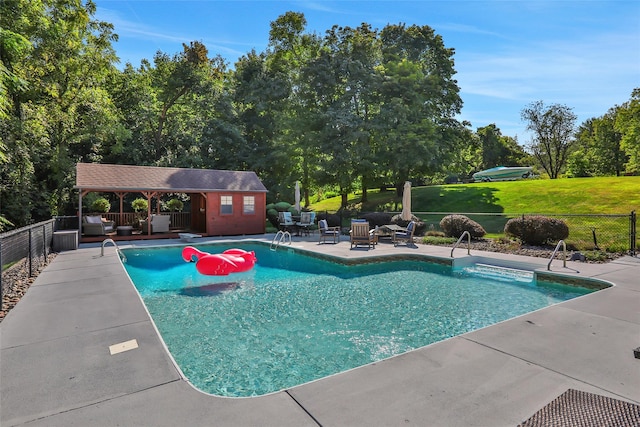 35 Lattintown Rd, Newburgh, NY 12550 - view of pool featuring outdoor lounge area, a patio, an outbuilding, and view of wooded area