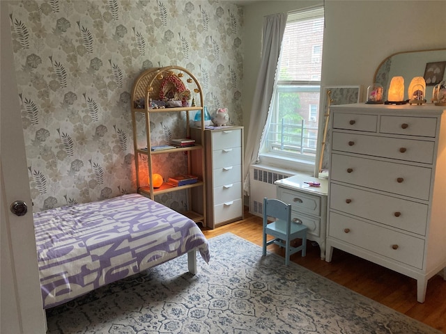 105-24 67th Ave Unit 4A, Forest Hills, NY 11375 - bedroom with radiator, light wood-type flooring, and wallpapered walls