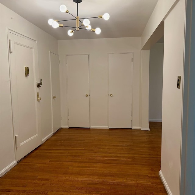 83-20 98th St Unit 1H, Woodhaven, NY 11421 - hallway featuring wood finished floors and a chandelier