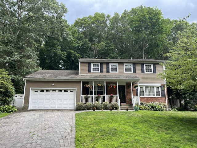 31A Nevinwood Pl, Huntington Station, NY 11746 - view of front of property with a porch, a garage, decorative driveway, a front lawn, and brick siding