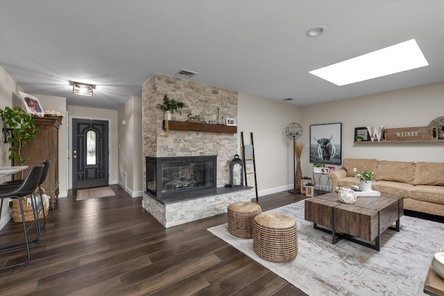 2854 Lenox Rd, Oceanside, NY 11572 - living room featuring a skylight, a fireplace, and wood finished floors