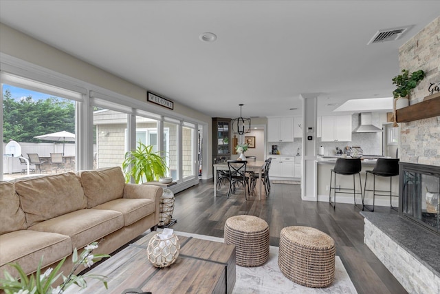 2854 Lenox Rd, Oceanside, NY 11572 - living room with dark wood-type flooring and a stone fireplace
