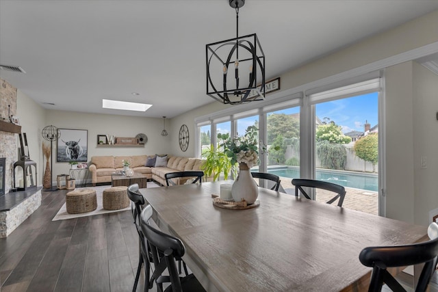 2854 Lenox Rd, Oceanside, NY 11572 - dining room with dark wood-type flooring, a skylight, and a chandelier