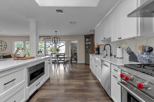 2854 Lenox Rd, Oceanside, NY 11572 - kitchen with exhaust hood, stainless steel appliances, decorative backsplash, decorative light fixtures, and white cabinets