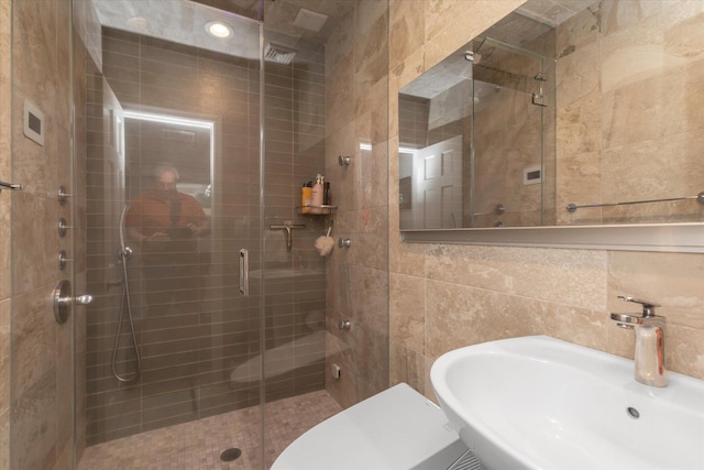 2854 Lenox Rd, Oceanside, NY 11572 - full bathroom featuring tile walls and a stall shower