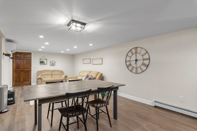 2854 Lenox Rd, Oceanside, NY 11572 - dining room featuring a baseboard radiator, a wall mounted air conditioner, recessed lighting, and wood finished floors
